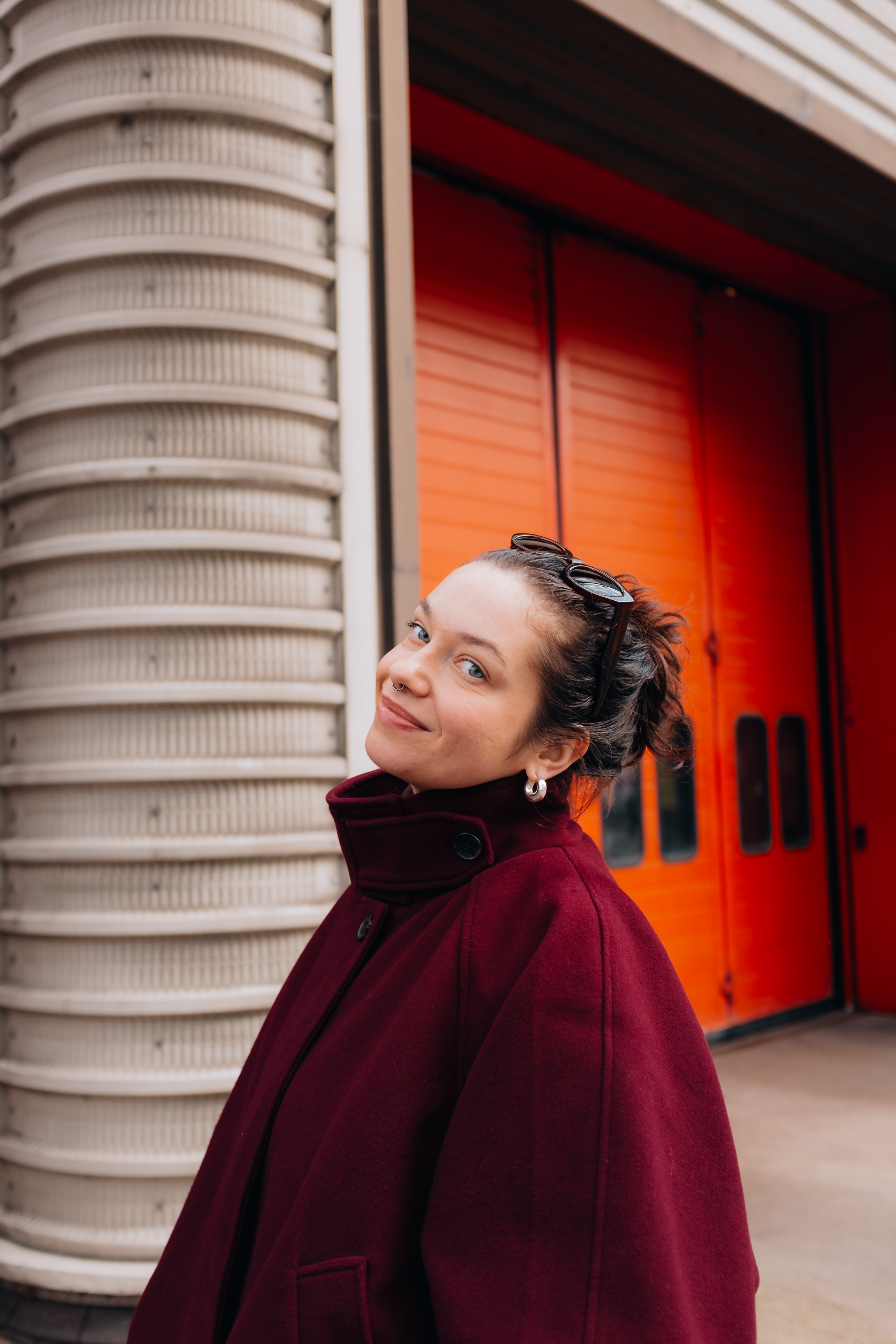 Denise in front of an orange doorway